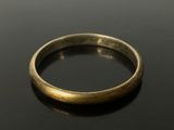 a close up of a gold ring on a black surface