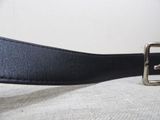 a close up of a black belt with a silver buckle