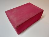 pink box on a white table with a white background