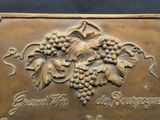 a plaque with a bunch of grapes on it