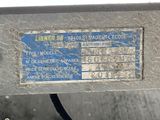 a label on the side of a machine that is sitting on the ground