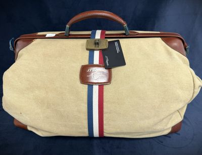 an old suitcase with a tag on it sitting on a blue background