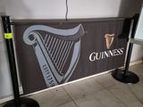 a sign that says guinness on it in front of a projector screen