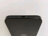 the back view of a black iphone with a camera attached to the back of it