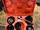 a red tool case with six tools inside of it