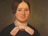 portrait of a woman in a black dress with a pink bow