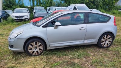 a silver car that is parked in the grass