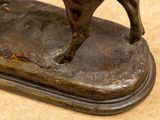 a bronze statue of a horse on a base