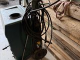 a machine that is sitting on the floor next to a pile of wood