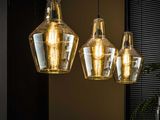 three lights that are hanging over a table