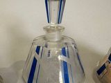 a glass bottle with a blue stripe on it
