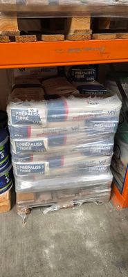 a stack of plastic containers sitting on a shelf in a warehouse