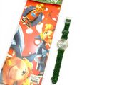 a watch sitting next to a book with a green strap