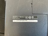a close up of a laptop with a sticker on it
