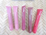 three tubes of lip care sitting next to each other on a bamboo mat
