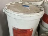 several buckets of cement sitting on top of each other in a room