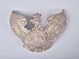 an image of a silver brooch with a crown on top of it