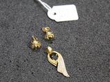 a close up of a pair of earrings and a tag on a table