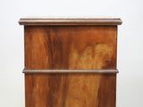 a wooden cabinet with a drawer on top of it