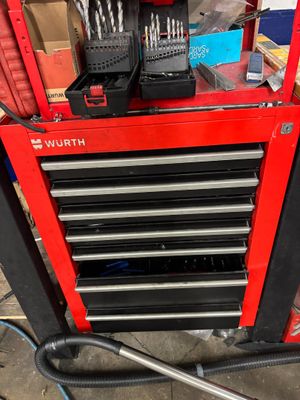 a red tool box with tools on top of it