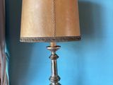 a lamp that is sitting on a table in front of a window