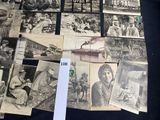 many old photographs of people on display on a table