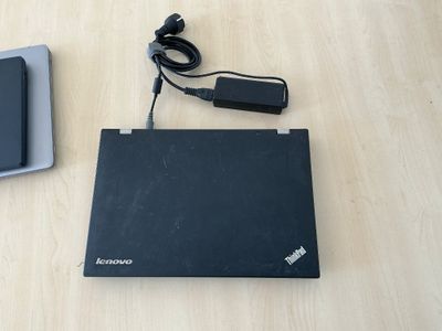 a laptop and a charger sitting on a table