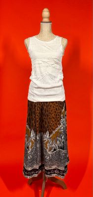 a mannequin with a white top and a leopard print skirt