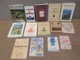 several books are sitting on a table in front of a wall