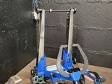 un porte-outils bleu sur lequel sont posées deux pinces