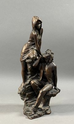 an image of a bronze statue of a woman and a man sitting on a rock
