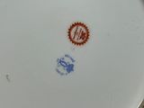 a white plate with a blue and red design on it