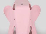 a small pink elephant that is sitting on a table