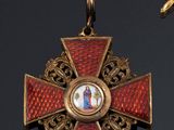 a red and gold cross with a picture of a woman on it