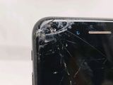 the broken screen of a cell phone is shown on a white surface