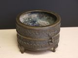a small metal bowl sitting on top of a table