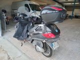a motorcycle parked in a garage with luggage on the back of it