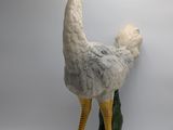 a statue of an ostrich that is standing on a rock