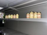 many jars of food on the shelves in the kitchen