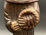 wooden figurine of a man holding a baby in his arms