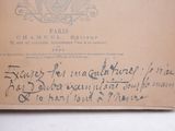 an old envelope with writing on it sitting on top of a table