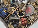 a box full of assorted jewelry on a table