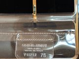 a clear box with a gold handle on a table