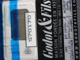 a close up of a blue and white electronic device on a table