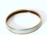 turquoise and gold bangle bracelet with black and white stripes