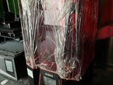 a picture of a machine wrapped in plastic in a kitchen