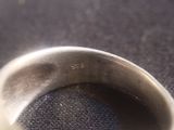 a close up of a silver ring on a table