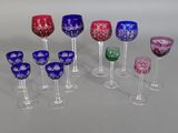many different colored wine glasses lined up on a table