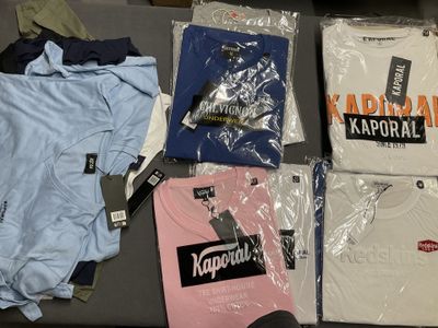 a lot of t - shirts that are on a table