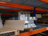 a shelf with boxes and boxes on it in a warehouse